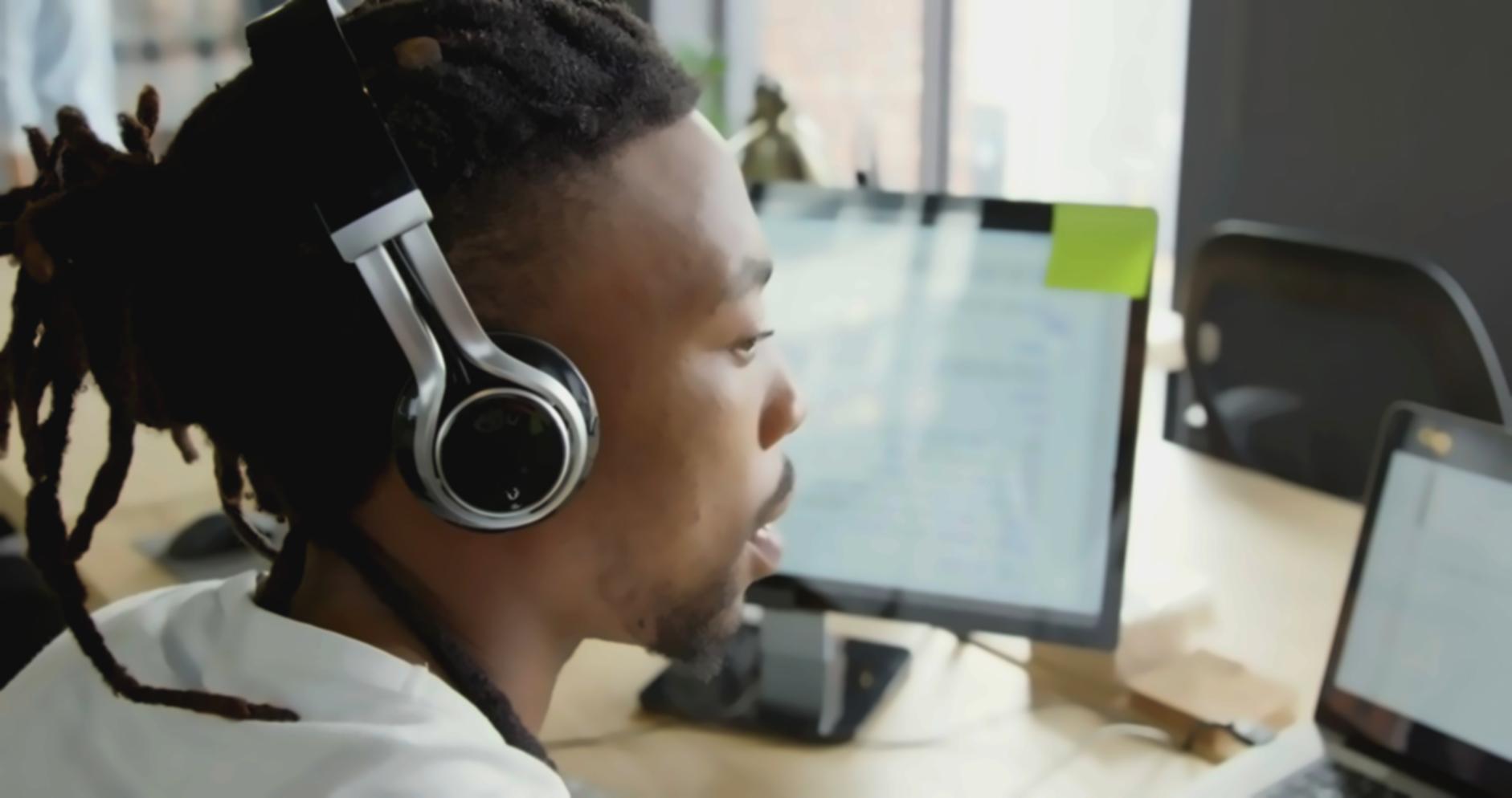 Team workspace with monitors displaying code and testing environments